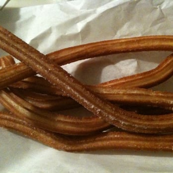 Churros & Funnel Cake - a pile of churros - Desserts Near Me