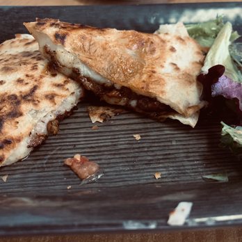 Takos and Beer - El Pastor appetizer quesadilla is outstanding!! This one is half gone, couldn't wait! - Tacos Near Me - Yuma, Arizona Takos and Beer - El Pastor appetizer quesadilla is outstanding!! This one is half gone, couldn't wait! - Tacos Near Me - Yuma, Arizona
