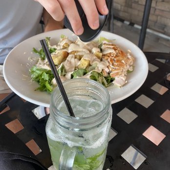 LiveOaks - a person sitting at a table with a plate of food - Burgers Near Me - Auburn, Alabama LiveOaks - a person sitting at a table with a plate of food - Burgers Near Me - Auburn, Alabama