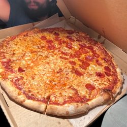 1/2 pepperoni & pineapple, 1/2 cheese & pineapple - notice the size of the pizza compared to my 20-year-old son's head!