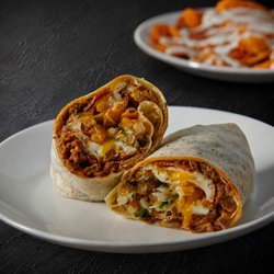 Fuego Cravings - A 13" flour tortilla packed with savory asada, crispy bacon, fluffy eggs, beans, golden fries, melted cheese, fresh onion, and cilantro.