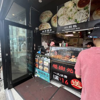 Lao Jie 老街 - man standing in front of a food stand - Chinese Near Me - Flushing, New York Lao Jie 老街 - man standing in front of a food stand - Chinese Near Me - Flushing, New York