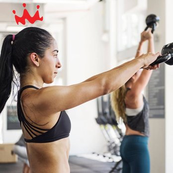 Smoothie King - a woman holding a kettlebell in a gym - Juice Bars & Smoothies Near Me - Pineville, Louisiana