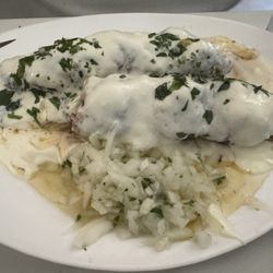 Sarkis - Kafta with yogurt. Sits on pitas and served with onions.