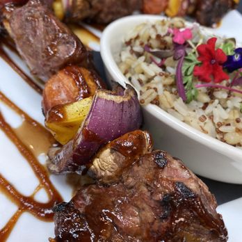 Char Grillhouse - a plate of meat and rice - New American Near Me - Wausau, Wisconsin