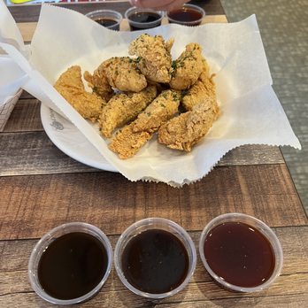 CM Chicken - Chicken tenders. With garlic soy, smoky bbq and red hot pepper sauces on the side. - Chicken Wings Near Me - Overland Park, Kansas