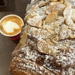 Café macchiato and almond croissant. Café macchiato and almond croissant.