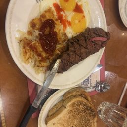 ny steak and eyeballs looking up with hash browns