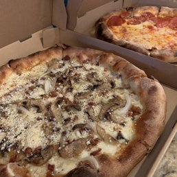 two pizzas in boxes