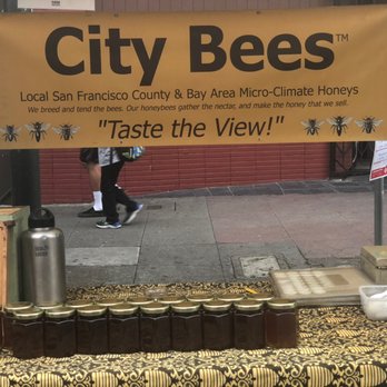 City Bees - a man standing in front of a table with jars of honey - Specialty Food Near Me City Bees - a man standing in front of a table with jars of honey - Specialty Food Near Me