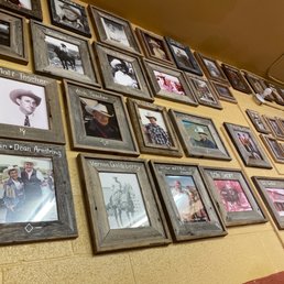 a wall full of framed photographs