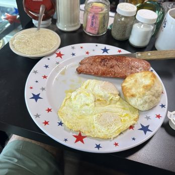 Masons - 2 Eggs over easy with country sausage and grits and a biscuit - Breakfast & Brunch Near Me - Milton, Florida Masons - 2 Eggs over easy with country sausage and grits and a biscuit - Breakfast & Brunch Near Me - Milton, Florida
