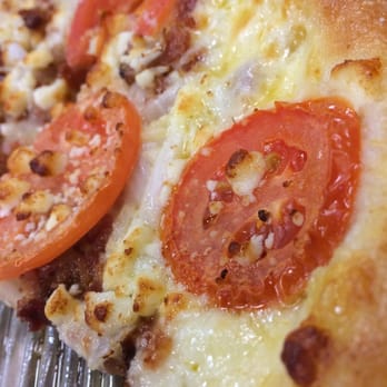 Marco's Pizza - a slice of pizza with tomatoes - Pizza Near Me - Oviedo, Florida