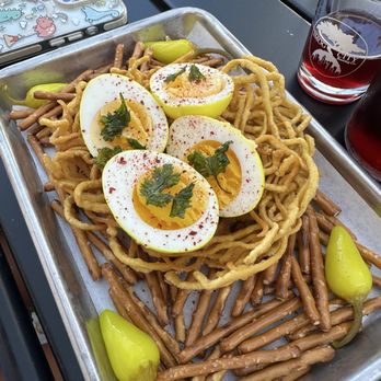 Smog City Heights - Pickled Eggs in a ramen noodle nest. The staffer taught me to bite pepper and squeeze juice on egg.Loved it like this since I like spicy! - Breweries Near Me - Long Beach, California