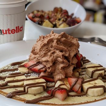 Nutella Cafe - Crepe with bananas, strawberries and Nutella whipped cream - Desserts Near Me - Chicago, Illinois Nutella Cafe - Crepe with bananas, strawberries and Nutella whipped cream - Desserts Near Me - Chicago, Illinois