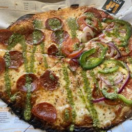 "Build your own" ... left side plain pep with oregano/basil and pesto drizzle. Right side pep, green pepper, onion and tomato "Build your own" ... left side plain pep with oregano/basil and pesto drizzle. Right side pep, green pepper, onion and tomato