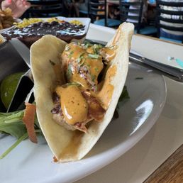 Mahi Mahi tacos, two in an order with fries or rice/beans. They have just a little heat to them making them delicious. Mahi Mahi tacos, two in an order with fries or rice/beans. They have just a little heat to them making them delicious.