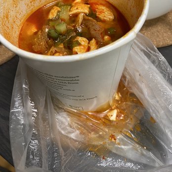 Minari - Tofu soup spilling out of the bottom of the Tupperware - Korean Near Me - San Bruno, California Minari - Tofu soup spilling out of the bottom of the Tupperware - Korean Near Me - San Bruno, California