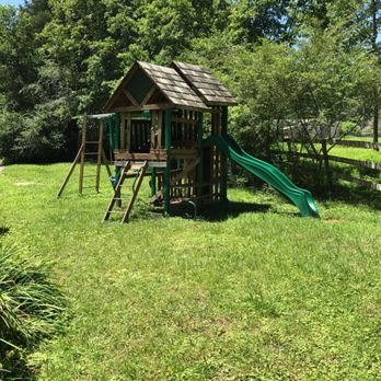 Clark's Bakery At Stone Cave - a wooden play structure with a green slide - Bakeries Near Me - Dunlap, Tennessee