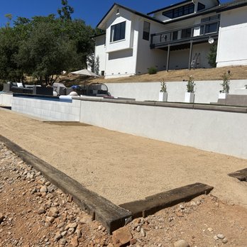 Precise Landscaping - a concrete retaining wall being installed in front of a house - Tree Services Near Me - Auburn, California Precise Landscaping - a concrete retaining wall being installed in front of a house - Tree Services Near Me - Auburn, California