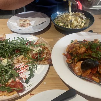 Gusto Ferrari - Arugula pizza, ink squid seafood spaghetti and cantindina - Pizza Near Me - Penticton, British Columbia