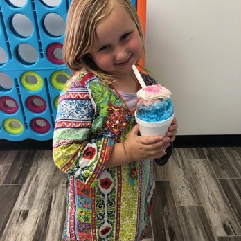 Pelican's SnoBalls - a little girl holding a cup of ice cream - Shaved Ice Near Me - Athens, Georgia Pelican's SnoBalls - a little girl holding a cup of ice cream - Shaved Ice Near Me - Athens, Georgia