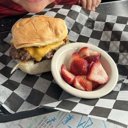 Burger with strawberries on the side