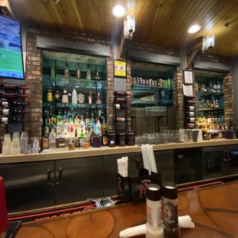 The Junction - Right bar area with two TVs and full bar - American Near Me - Snowshoe, West Virginia The Junction - Right bar area with two TVs and full bar - American Near Me - Snowshoe, West Virginia