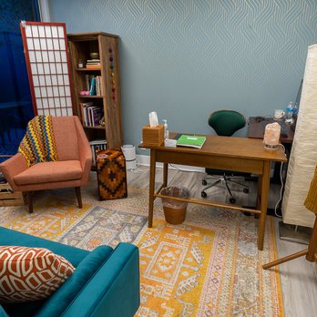 AH Construction - a living room with a blue couch and a wooden table - General Contractors Near Me - San Diego, California AH Construction - a living room with a blue couch and a wooden table - General Contractors Near Me - San Diego, California