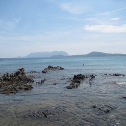Pittulongo Beach - paddle-boarding at Spiaggia Pittulongu or Pittulongu Beach, Olbia, Sardinia Island, Italy
