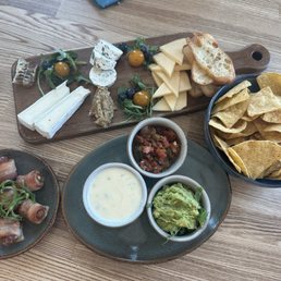 Cheese board, chips and dip, bacon-wrapped dates