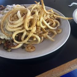 Uncle Jack's Bar & Grill - Delicious Philly cheesesteak sandwich, fresh curly fries, and a side of queso for dipping. Looks and tastes great!