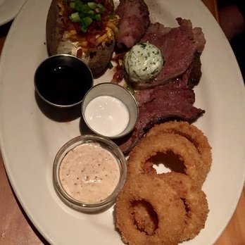 Black Angus Steakhouse - USDA Choice Prime Rib w/ onion rings and loaded baked potato - Steakhouses Near Me - Burbank, California
