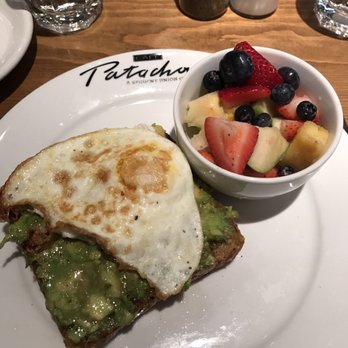 Cafe Patachou - Avocado toast with a fried egg and a side of fruit - Breakfast & Brunch Near Me - Carmel, Indiana Cafe Patachou - Avocado toast with a fried egg and a side of fruit - Breakfast & Brunch Near Me - Carmel, Indiana