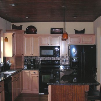Project Express - a kitchen with black appliances and wood cabinets - General Contractors Near Me - Loveland, Ohio