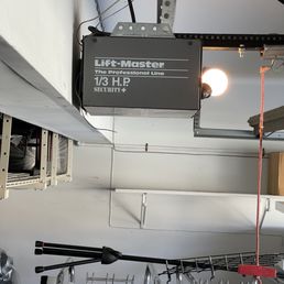 Garage door opener mounted to a beam without easy access to buttons in the back. Garage door opener mounted to a beam without easy access to buttons in the back.