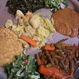 Veggie dishes family platter with injera