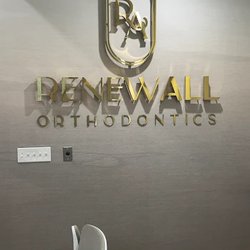 RenewAll Orthodontics office lobby featuring branded wall signage and modern orthodontic practice interior.