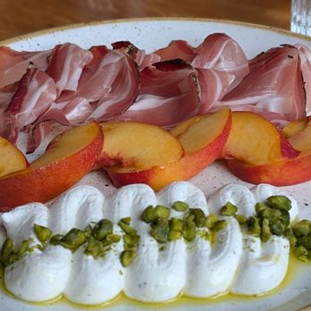 Osteria Savio Volpe - Speck with whipped ricotta, pistachios, nectarines. - Italian Near Me - Vancouver, British Columbia