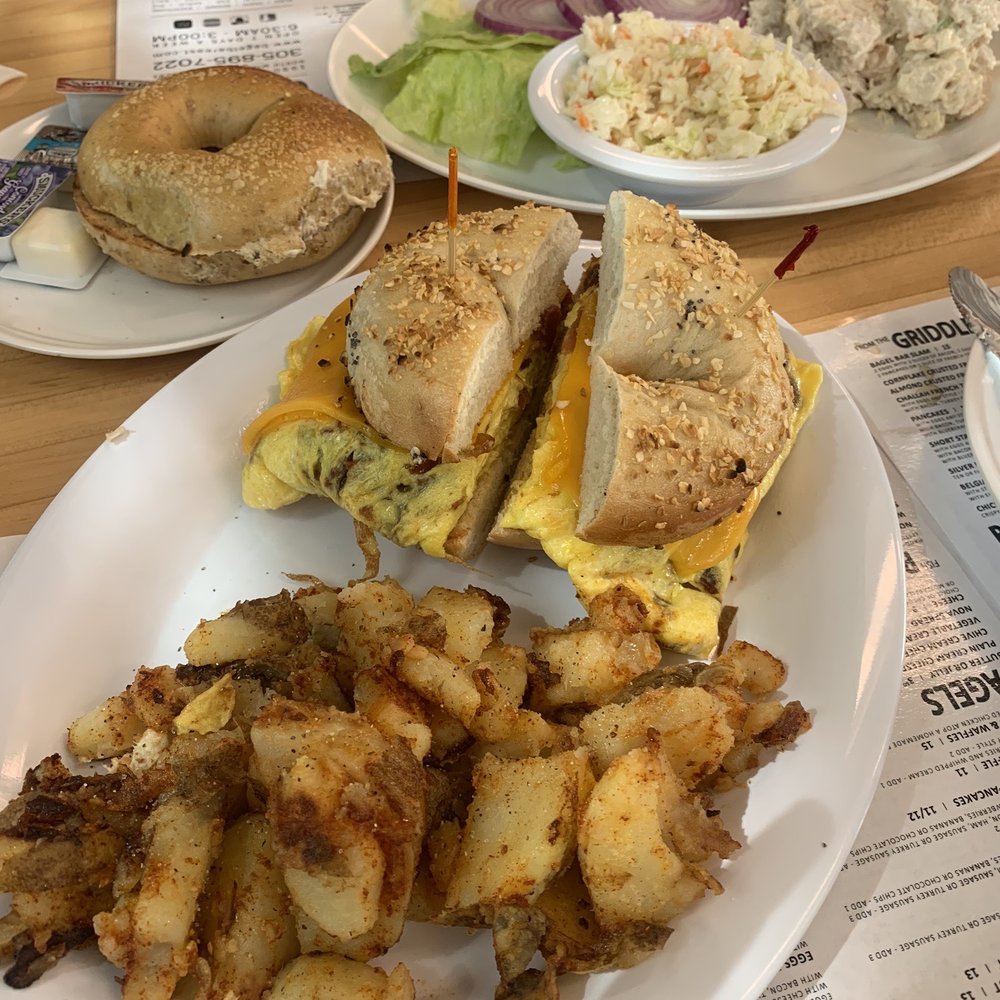 Bagel Bar East - Bacon, egg & cheese on a onion bagel and home fries. Chicken salad with plain bagel and coleslaw. - Bagels Near Me - North Miami, Florida Bagel Bar East - Bacon, egg & cheese on a onion bagel and home fries. Chicken salad with plain bagel and coleslaw. - Bagels Near Me - North Miami, Florida