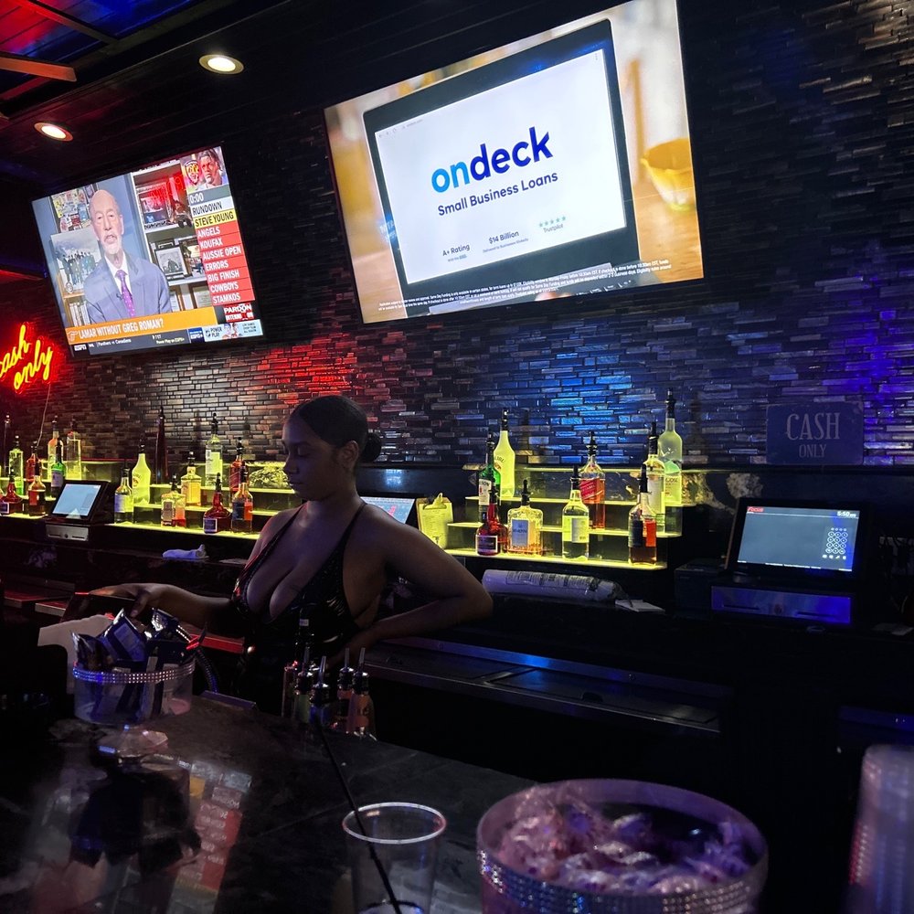 Blue Flame Lounge - a man sitting at the bar - Strip Clubs Near Me - Atlanta, Georgia