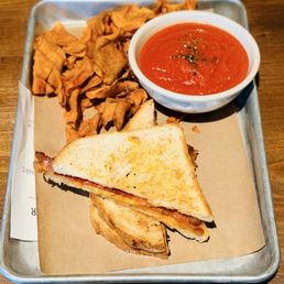 Adult grilled cheese with sweet potato chips and a sub side of tomato soup