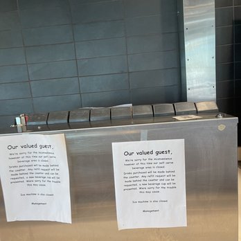 McDonald's - a stainless steel counter with two signs on it - Burgers Near Me - Longwood, Florida
