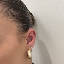 (Top part of ear) Helix & conch piercing. (Top part of ear) Helix & conch piercing.