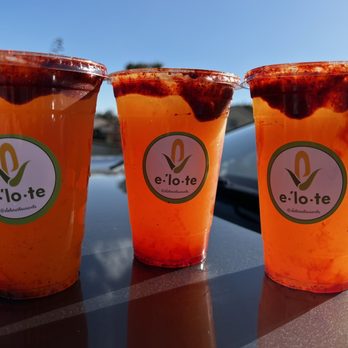 Elote - three cups of orange juice on a table - Mexican Near Me - San Diego, California Elote - three cups of orange juice on a table - Mexican Near Me - San Diego, California