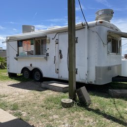 a taco truck parked on the side of the road a taco truck parked on the side of the road