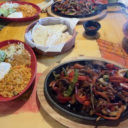 Beef Fajitas, flour tortillas, rice beans, guac and sour cream.