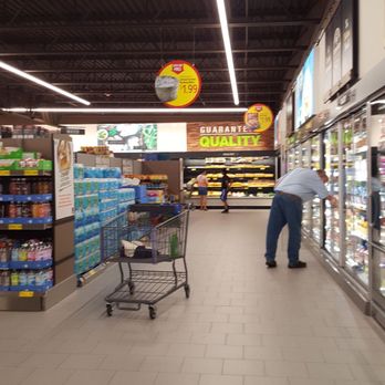 ALDI - a man pushing a shopping cart in a grocery store - Grocery Near Me - Roseville, Minnesota