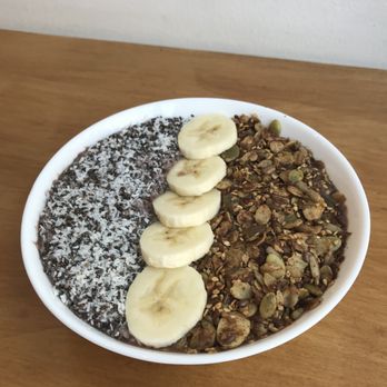ROOTS - Acai Bowl (€7.50): almond milk, banana, almond butter, lemon juice, date, vanilla, cinnamon; toppings (not in description, but seen here) - Organic Stores Near Me - Amsterdam, New Hampshire