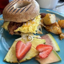 Wheat bagel w hash browns cheese egg & bacon, potatoes, fresh cut fruit Wheat bagel w hash browns cheese egg & bacon, potatoes, fresh cut fruit